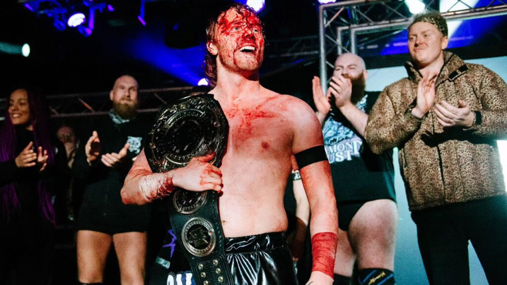 Kid Lykos covered in blood, celebrating winning the Progress Championship from Spike Trivet