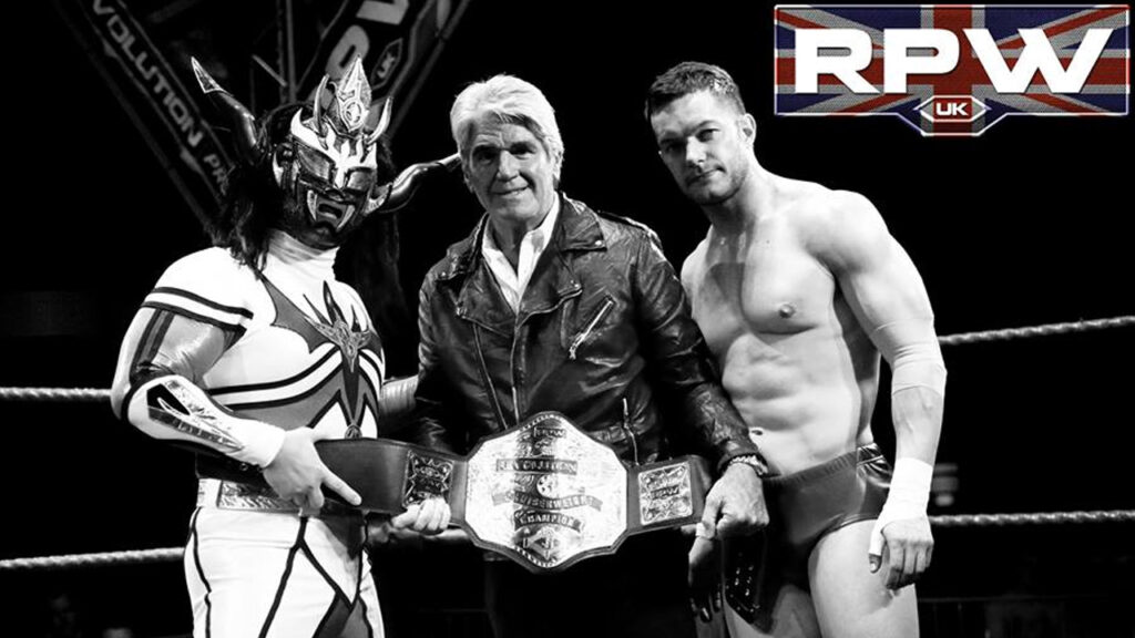 Jushin Liger, Prince Devitt and Mark Rocco pose with the British Cruiserweight title at RevPro When Thunder Strikes.