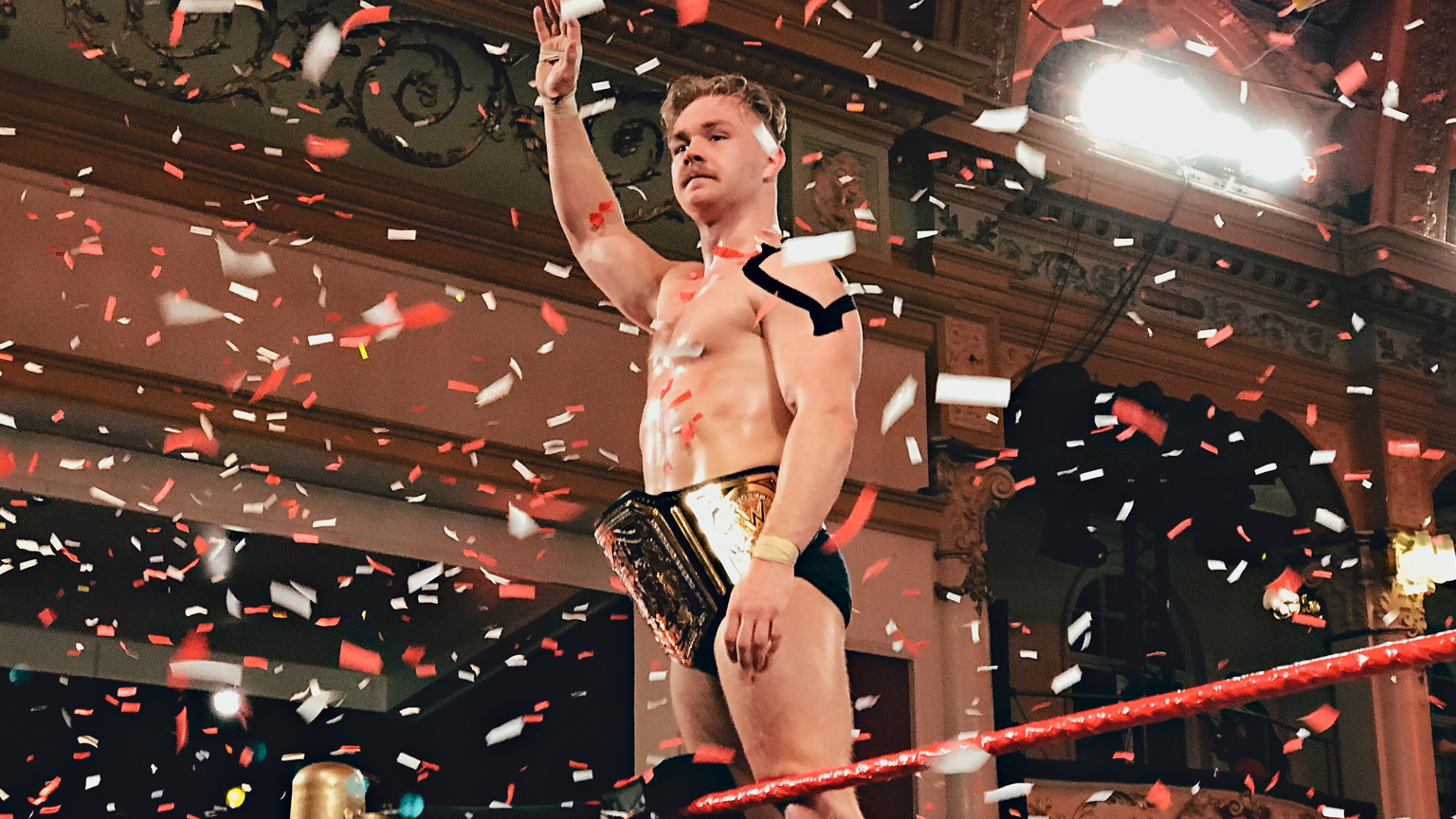 Tyler Bate celebrates becoming the first WWE UK Champion.